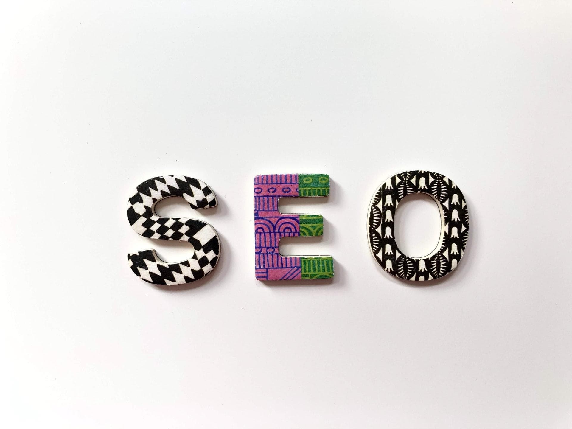 Colorful letters S, E, and O on white background